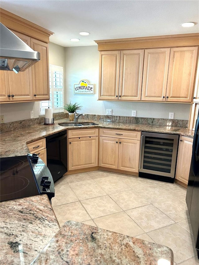 kitchen featuring beverage cooler, light brown cabinets, a sink, black appliances, and wall chimney exhaust hood