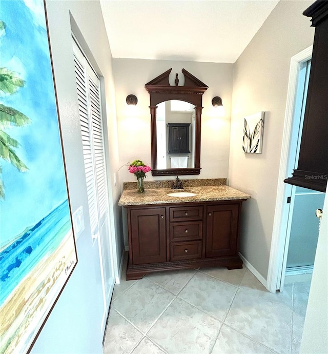 bathroom with tile patterned floors, vanity, and baseboards