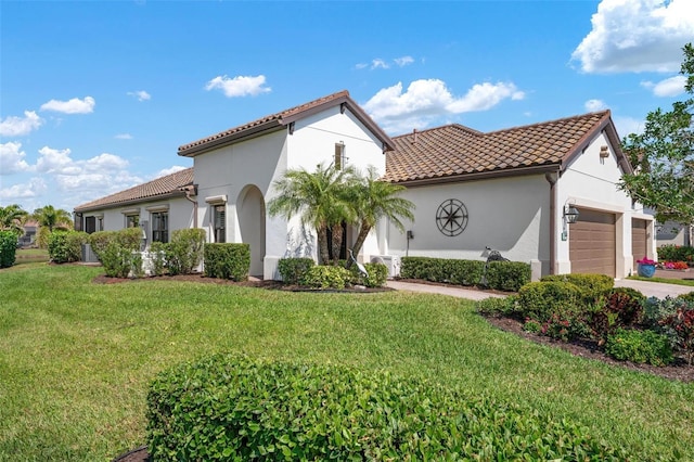 mediterranean / spanish home featuring a garage, a tiled roof, a front lawn, and stucco siding