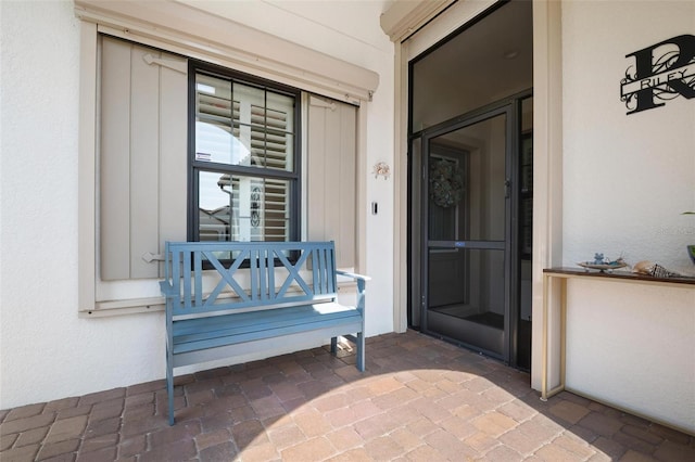 view of exterior entry with stucco siding