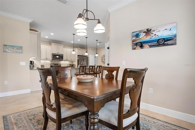 dining area with light tile patterned floors, baseboards, and crown molding