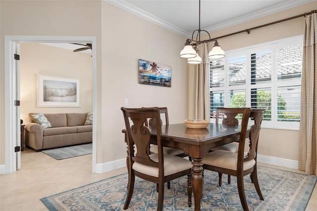 dining room featuring a chandelier, crown molding, baseboards, and light tile patterned floors