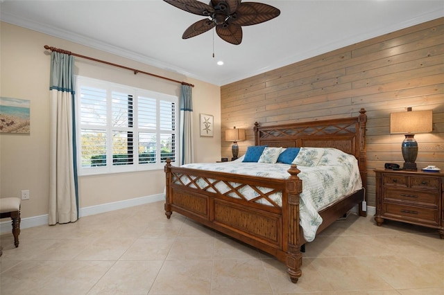 bedroom featuring ceiling fan, light tile patterned flooring, wood walls, baseboards, and ornamental molding