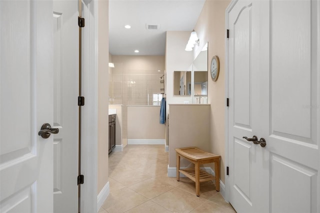 full bathroom with visible vents, baseboards, tile patterned flooring, walk in shower, and vanity