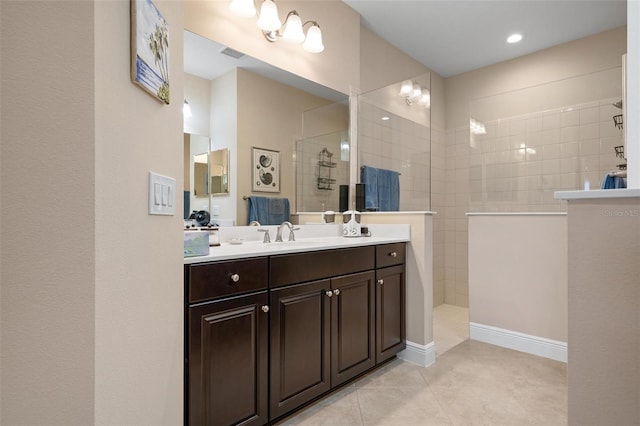 bathroom with tile patterned floors, visible vents, walk in shower, and vanity