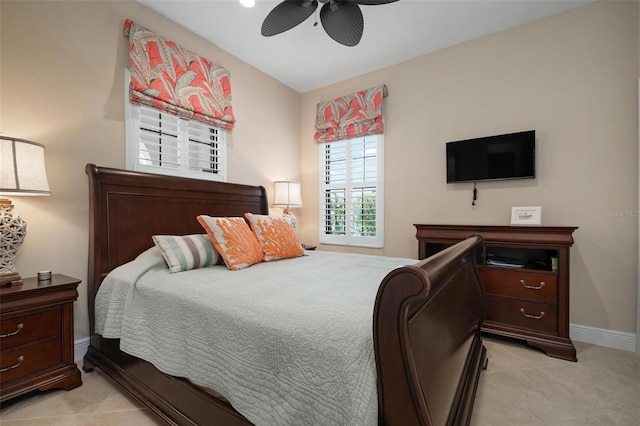 bedroom featuring ceiling fan, light tile patterned flooring, and baseboards