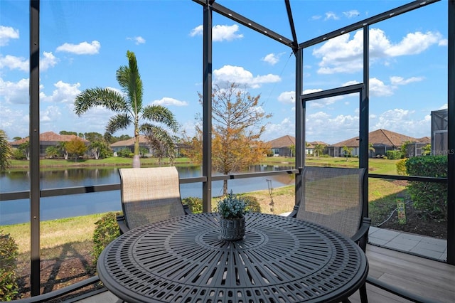 sunroom / solarium featuring a water view