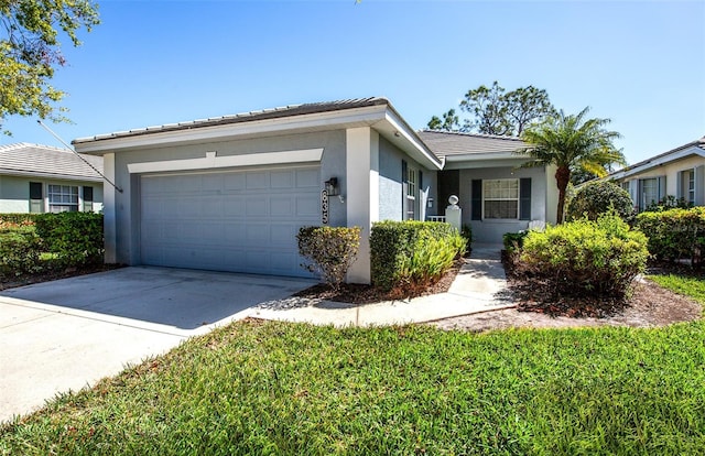 single story home featuring an attached garage, a tile roof, concrete driveway, and stucco siding