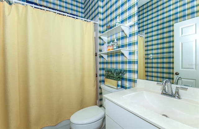 bathroom featuring toilet, wallpapered walls, a shower with curtain, and vanity