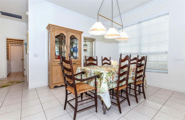 dining room with ornamental molding and light tile patterned flooring