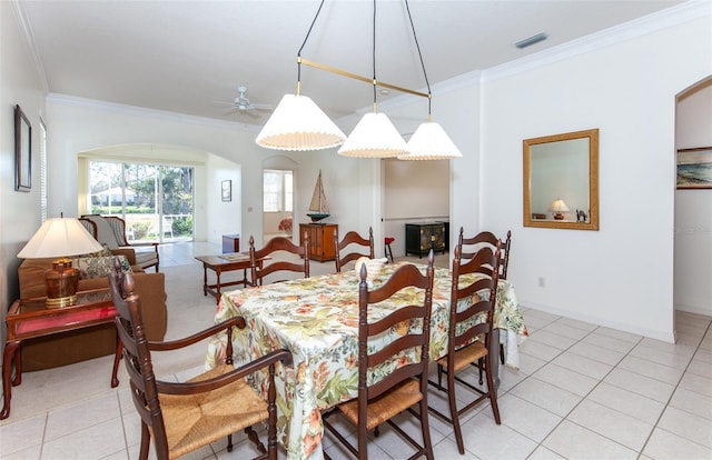 dining space featuring light tile patterned flooring, visible vents, and crown molding