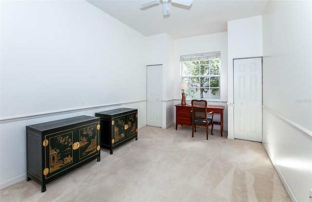 carpeted office with a ceiling fan and baseboards