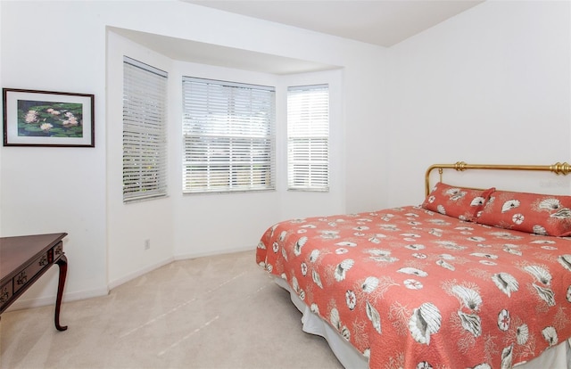 bedroom featuring carpet and baseboards