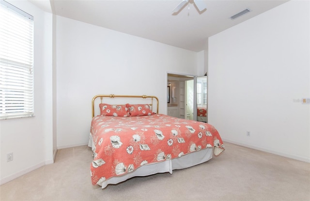 carpeted bedroom with visible vents, ceiling fan, and baseboards