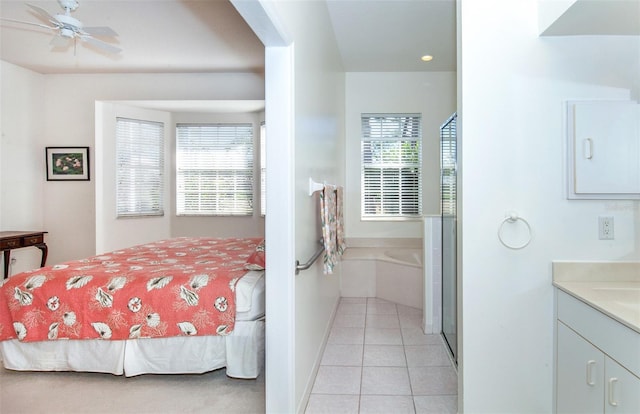 bedroom with light tile patterned floors, multiple windows, and baseboards