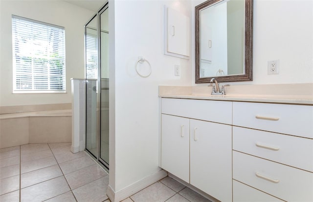 full bathroom with a stall shower, vanity, and tile patterned floors