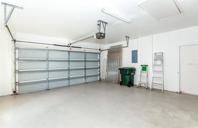 garage featuring electric panel and a garage door opener