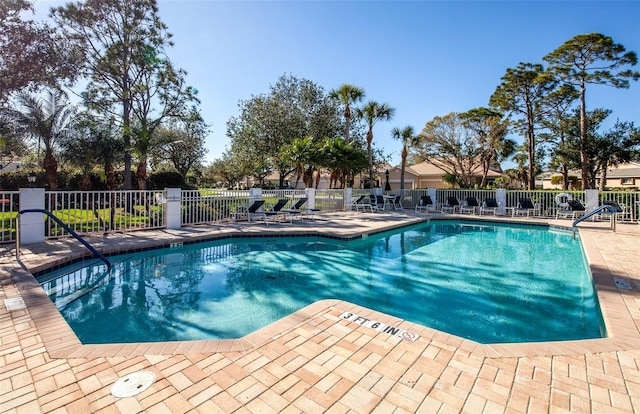 view of swimming pool with fence and a patio