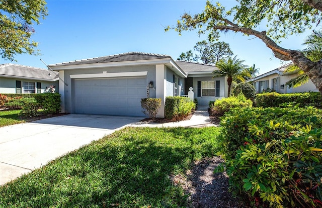 ranch-style house with driveway, an attached garage, a tile roof, and stucco siding