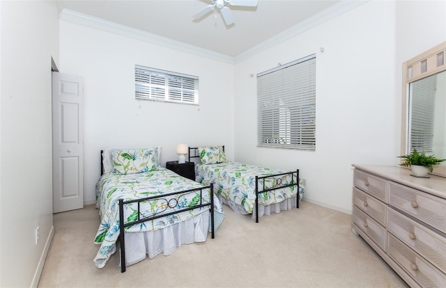 bedroom with light carpet, ceiling fan, baseboards, and crown molding