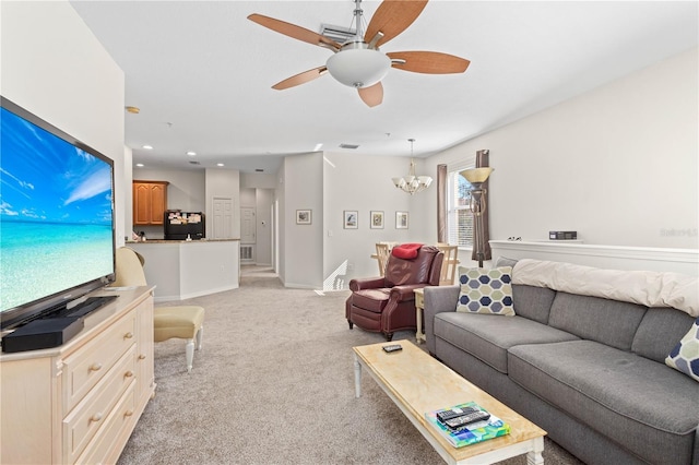 living area featuring light carpet, recessed lighting, ceiling fan with notable chandelier, and baseboards