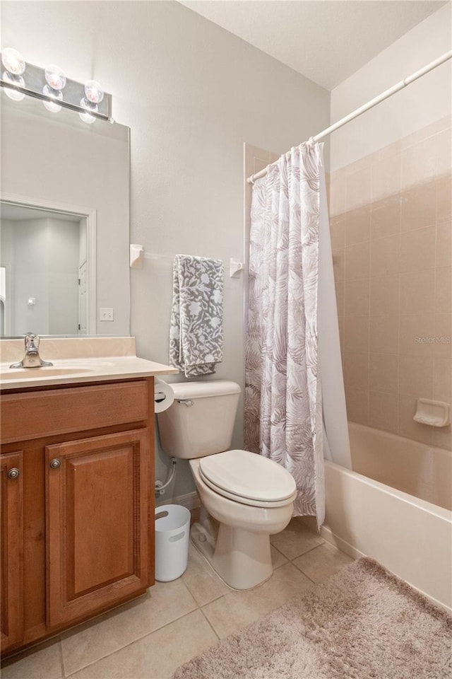 full bath featuring shower / bath combination with curtain, tile patterned flooring, vanity, and toilet