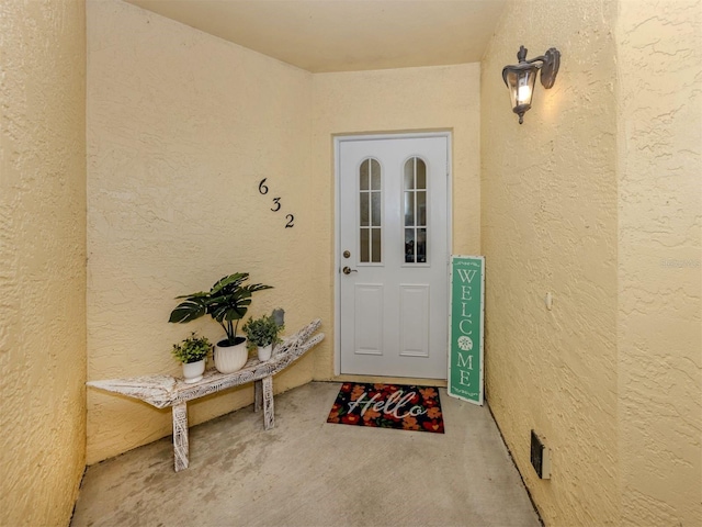 property entrance featuring stucco siding