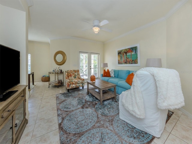 living area featuring a ceiling fan, baseboards, crown molding, and light tile patterned flooring