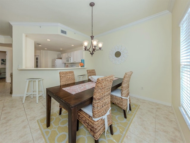 dining room featuring light tile patterned floors, baseboards, visible vents, and crown molding