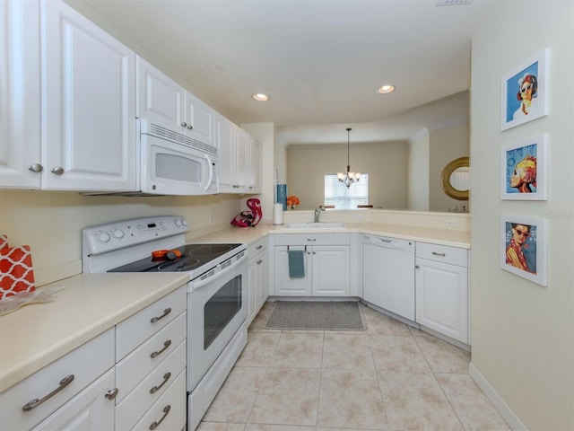 kitchen with decorative light fixtures, light tile patterned floors, white cabinetry, a sink, and white appliances