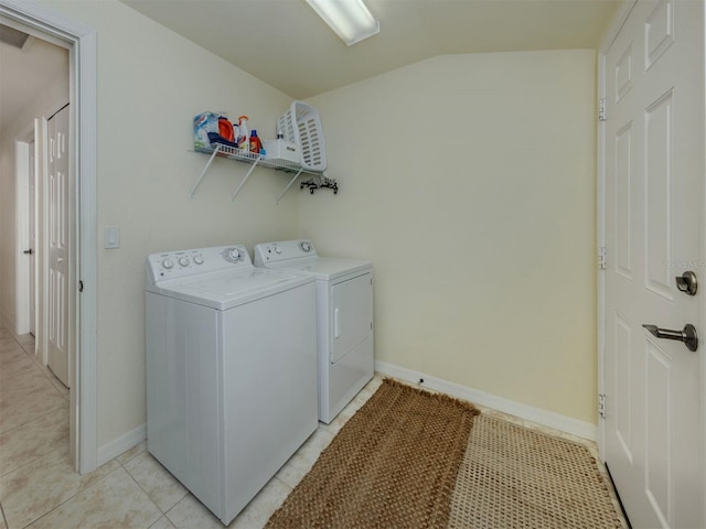 clothes washing area featuring laundry area, independent washer and dryer, baseboards, and light tile patterned floors