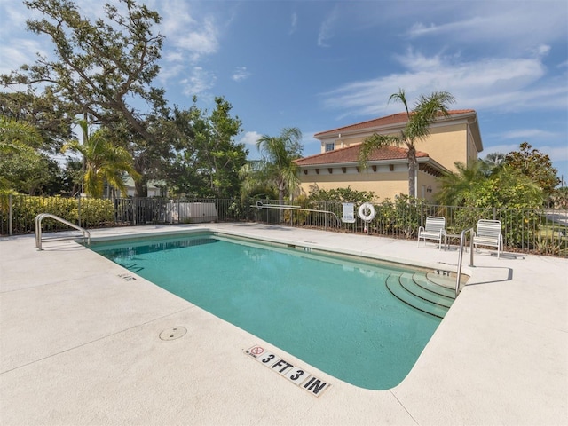 pool featuring a patio area and fence