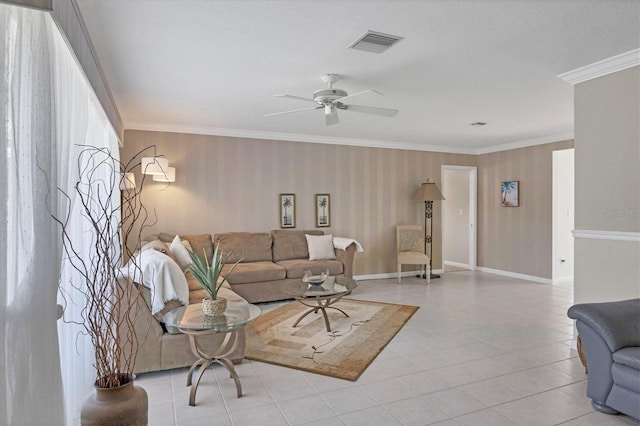living area featuring light tile patterned floors, ceiling fan, visible vents, baseboards, and ornamental molding
