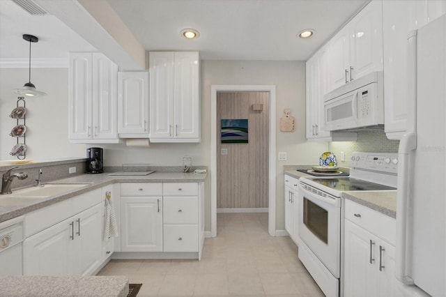 kitchen featuring light countertops, white appliances, white cabinetry, and a sink