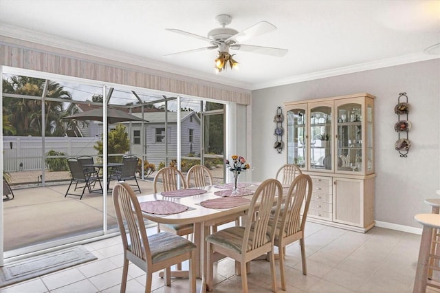 dining room with light tile patterned floors, baseboards, ornamental molding, and ceiling fan