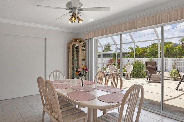 dining space with a ceiling fan, light tile patterned flooring, and crown molding