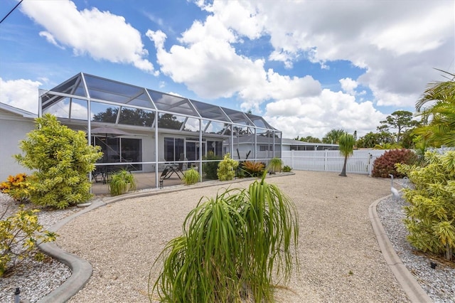 exterior space with glass enclosure, a patio area, and fence