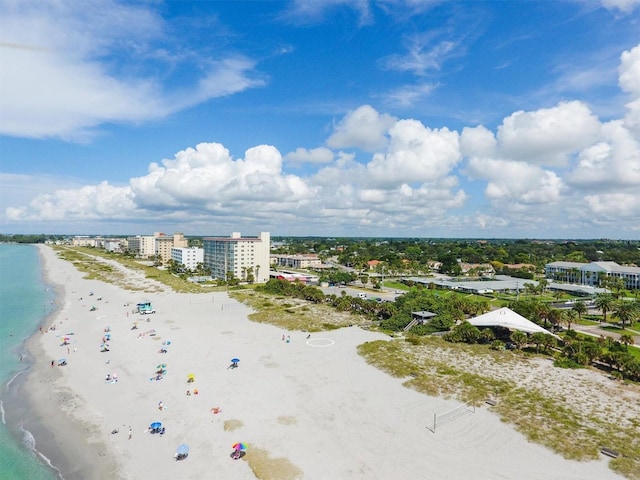 bird's eye view featuring a view of city, a water view, and a beach view