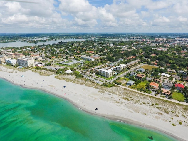 bird's eye view with a city view, a water view, and a beach view