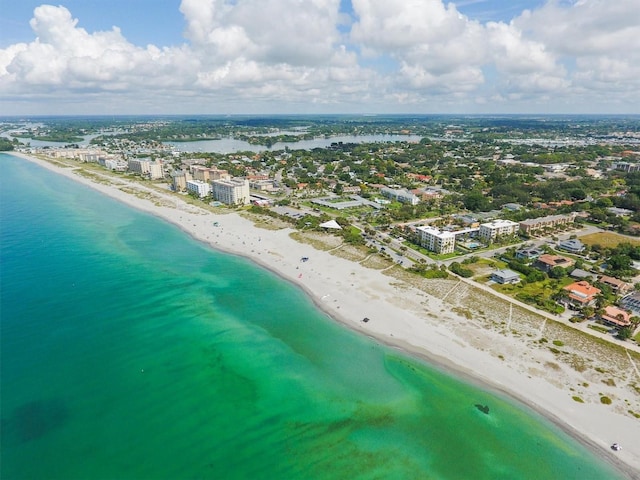birds eye view of property with a city view, a water view, and a beach view