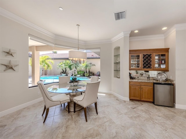 dining room with baseboards, visible vents, recessed lighting, crown molding, and indoor bar