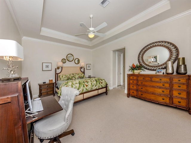 carpeted bedroom with ceiling fan, a raised ceiling, visible vents, and ornamental molding