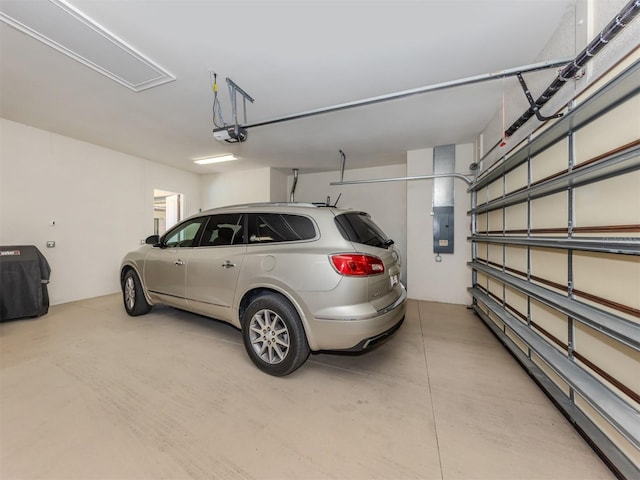 garage with electric panel and a garage door opener