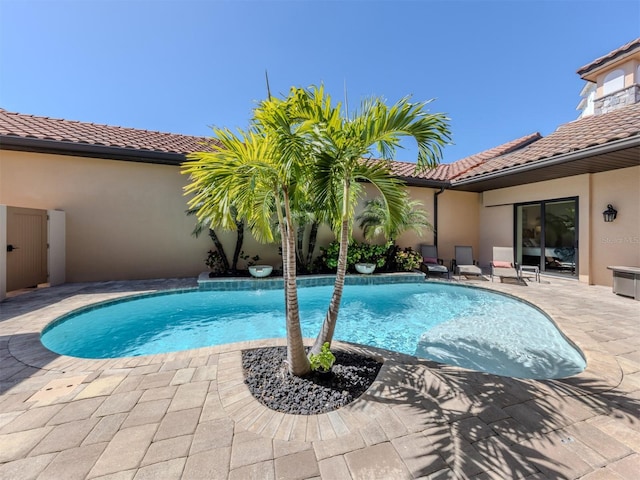 outdoor pool with a patio area