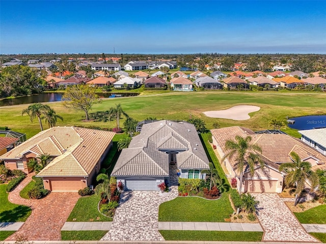 birds eye view of property with a residential view, a water view, and golf course view