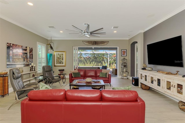 living room with arched walkways, ornamental molding, wood finished floors, and visible vents