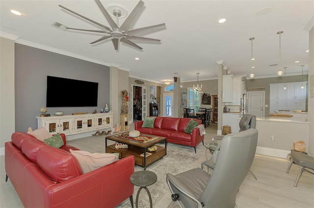 living area with light wood-style floors, crown molding, and recessed lighting