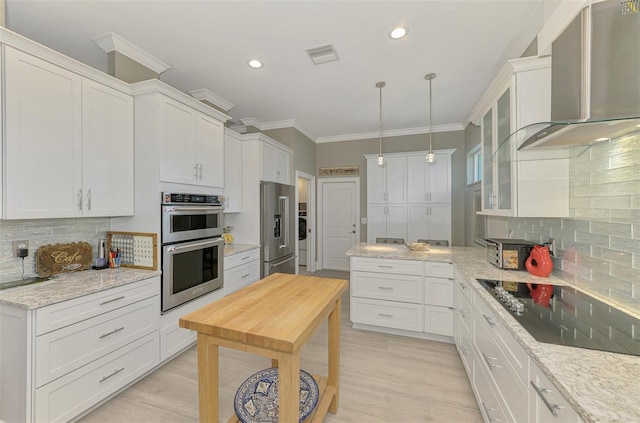 kitchen featuring visible vents, white cabinets, glass insert cabinets, stainless steel appliances, and wall chimney range hood