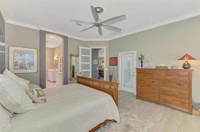 bedroom with ornamental molding, light wood finished floors, and arched walkways