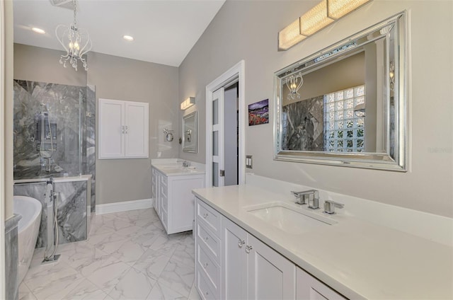 bathroom featuring marble finish floor, a soaking tub, two vanities, a sink, and baseboards